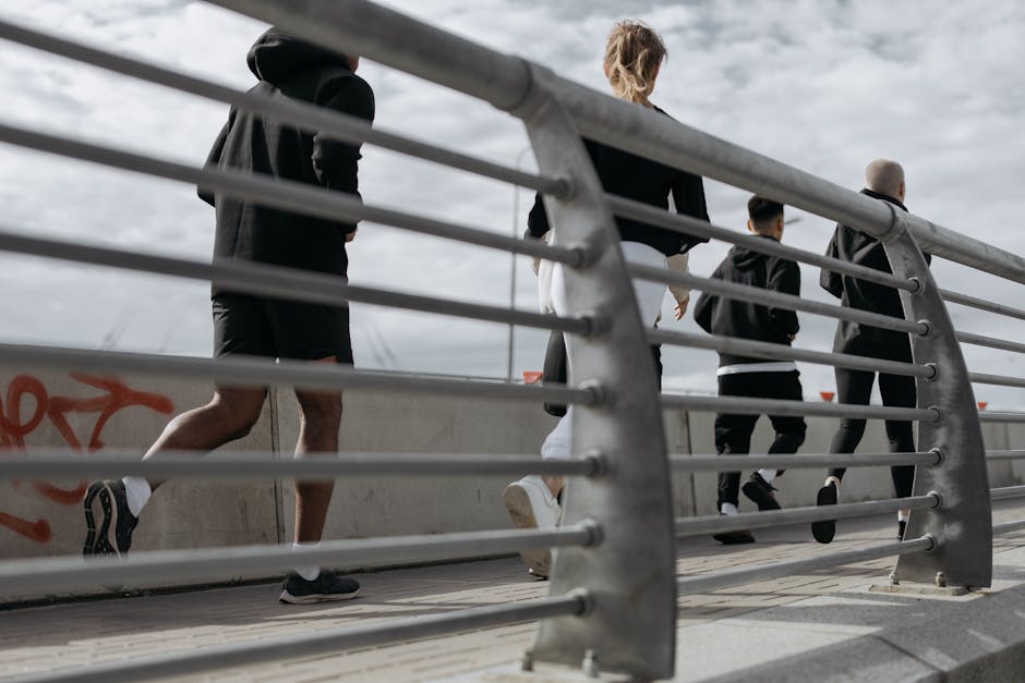 A group jogging outdoors on an urban bridge, promoting fitness and wellness